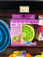 Retail display photo of Catstages Kitty Lickin' Layers puzzle feeder in packaging