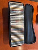 View of zippered case open with CDs visible edge labels