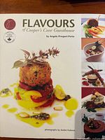 Front cover showing title, author, and plated dish photo collage