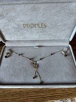 Necklace and earrings displayed in Peoples Jewellers case