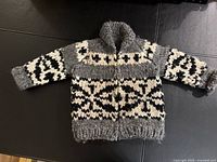 Front view of grey, black and white wool child sweater