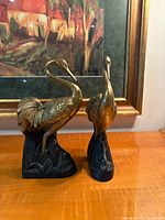 Front angled view of both brass heron bookends