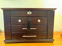 Front view of closed wooden jewelry box