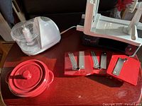 All items grouped: chopper, spiral slicer with three blades, red baker