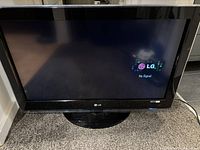 Front view of LG TV powered on displaying LG logo