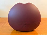 Front view of Saje Aroma Breeze diffuser showing brand and on/off button