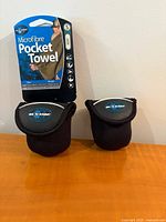 Front view of both Sea to Summit Pocket Towels in cases with retail card showing brand and size