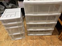 Large white 4-drawer unit and small white 3-drawer unit side by side