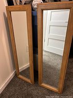 Front view of both oak framed mirrors showing size and matching design
