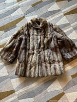 Front view of vintage fur jacket showing overall style and closure