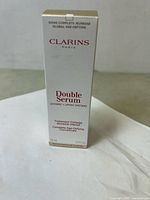 Front view of the Clarins Paris Double Serum white box showing the product name and key info.