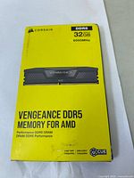 Front of the packaging showing Corsair Vengeance DDR5 Memory for AMD, 32GB total capacity, 6000MHz frequency.