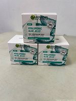 Three new boxes of Garnier Skin Naturals Hyaluronic Aloe Jelly arranged in a pyramid shape on white background.