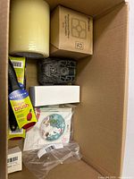 Overview of box contents including Parmer filter box, digital watch band kit, adhesives, brushes, and kitchen tools.