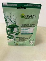 Front close-up of Garnier SkinActive Moisture Bomb biodegradable sheet mask box showing branding, hydration claims.