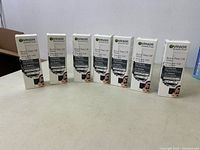 Lot of seven Garnier SkinActive Black Peel-Off Charcoal Mask boxes lined up in a row.