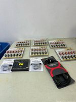 Full lot of music accessories including multiple packages of speaker connectors, guitar strings, ear plugs, and cable