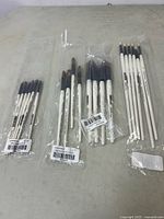 Lot of Simply Simmons paint brushes grouped and sealed in original packaging showing all types and quantities.
