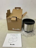 Breville Knock Box 10 with original box and manual shown open on table