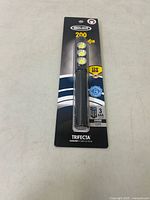 Full front view of the Police Security Trifecta flashlight in original packaging showing three LED lights and branding.