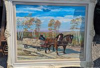 Front view of framed oil painting showing two horses pulling a cart of logs with a man driving, signed by artist A.C. Maurice 1964.