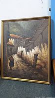 Framed oil painting depicting atmospheric narrow alley scene with walking figure, signed F Ciron.
