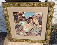 Square gilt wood frame holding a 10-inch square art print showing a young woman and a frog in a nature scene under daylight.