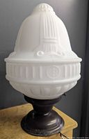 Front view showing the full fixture and opaque glass shade design