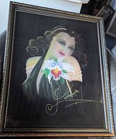 Full view of framed mixed media portrait of woman with orchid flower, showing overall artwork and frame condition.
