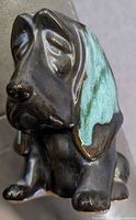 Angled side view showing the dog's profile, glaze colors, and facial features.