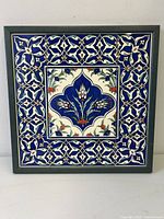 Front view of framed vintage Isnic pattern porcelain tile collage with vibrant blue and floral design.