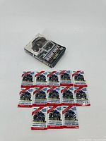 Photo showing 13 Bigfoot Monster Truck trading cards laid out in front of card collector box