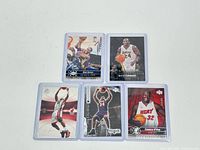 Five basketball cards displayed, two featuring Kobe Bryant in Lakers uniforms and three featuring Shaquille O'Neal in Lakers and Miami Heat jerseys, each encased in protective sleeves.