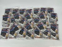 Thirty Beckett Baseball Card Monthly booklets laid out, each sealed in plastic with included card packets visible.