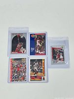 Top-down photo showing all five Michael Jordan cards in protective plastic sleeves arranged in a semi-circle.