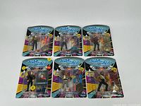 Full view of 6 Star Trek: The Next Generation action figures in original packaging, showing front of cards and figures.