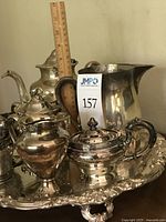 View showing six-piece silver-plated tea and coffee set on tray with ruler indicating height of tallest pot approximately 10-11 inches.