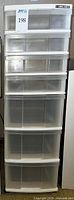 Front view of the tall 7-drawer plastic storage unit showing clear drawers and white frame.