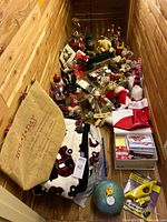 Wide angle shot of the holiday decor collection including large blanket, stuffed animals, hats, and assorted figures.