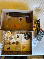 Upper tray overview of jewelry items including chains, rings, bead cluster and box of beads