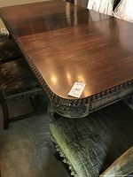 Table top showing two leaves inserted and carved border detailing