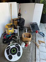 Wide view of all items in the lot, including resistance bands, metal foot massager, Revitive booster, wooden massagers, electronic pulse massager, pedal exerciser.