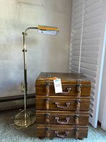 Full view showing the floor lamp and the 4-drawer chest styled as luggage