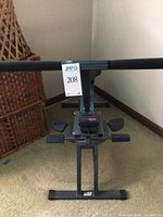 Front view of HealthRider aerobic fitness machine showing padded seat, digital monitor, arm handles, and footrests on a metal frame.