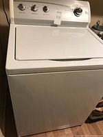 Kenmore top-loading washing machine in white with control panel and lid closed, showing front and top angled view.
