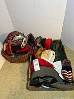 Full view of the lot showing hats, scarves, gloves and accessories arranged in baskets and on the floor.