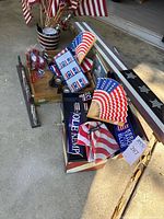 Mixed lot with various patriotic USA themed items including flags, fans, cups, and campaign signage.