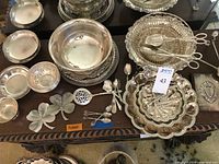 Multiple silver plated pieces arranged on table
