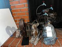 All items grouped together near fireplace showing lantern, horse sculpture, pig and bird figurines