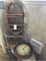 Full view showing all five items stacked and leaning against a wall including oval shelf, corner shelf, peg rack, wall clock, and corner bench.